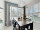 Bright dining area featuring a wooden table, stylish chandelier, and large window for ample natural light at 4820 Battaglia Blvd, St Cloud, FL 34769