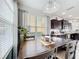 Bright dining area featuring a wooden table, stylish chandelier, and large window for ample natural light at 4820 Battaglia Blvd, St Cloud, FL 34769