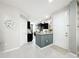 Entryway with gray tile floors leads to the kitchen with dark wood cabinets at 4820 Battaglia Blvd, St Cloud, FL 34769