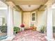 Welcoming entryway with brick pavers, decorative plants, and a cozy bench at 4820 Battaglia Blvd, St Cloud, FL 34769