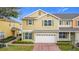 Inviting two-story home featuring a brick driveway, attached two car garage and beautiful landscaping at 4820 Battaglia Blvd, St Cloud, FL 34769