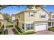 Charming two-story home with a brick driveway, lush landscaping, and attached two car garage at 4820 Battaglia Blvd, St Cloud, FL 34769