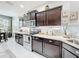 Updated kitchen with stainless steel appliances, granite countertops, and dark wood cabinets at 4820 Battaglia Blvd, St Cloud, FL 34769