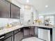 Kitchen features stainless steel appliances, a double sink, and dark wood cabinets at 4820 Battaglia Blvd, St Cloud, FL 34769