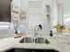Kitchen with a stainless steel double sink and stylish granite countertops at 4820 Battaglia Blvd, St Cloud, FL 34769