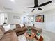 Comfortable living room with a large sectional sofa, ceiling fan, and mounted television for cozy gatherings at 4820 Battaglia Blvd, St Cloud, FL 34769