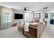 Spacious living room featuring an oversized sectional sofa, large television, and plenty of natural light at 4820 Battaglia Blvd, St Cloud, FL 34769