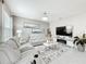 Inviting living room featuring comfortable reclining seating, tile floors, and modern decor at 4820 Battaglia Blvd, St Cloud, FL 34769