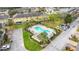 Aerial view of community pool surrounded by townhomes, manicured landscaping, lounge chairs, and parking at 4820 Battaglia Blvd, St Cloud, FL 34769