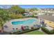 Community pool with lounge chairs, cabana, and landscaping in a townhome community at 4820 Battaglia Blvd, St Cloud, FL 34769
