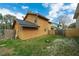 Backyard area featuring grassy space, wood fence, and the exterior of the home at 486 Abba St, Altamonte Springs, FL 32714