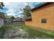 A backyard with grass and partial fencing, with the exterior of the home on the right at 486 Abba St, Altamonte Springs, FL 32714