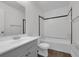 Well-lit bathroom featuring a tub, shower, toilet, vanity, and white subway tile with black trim at 486 Abba St, Altamonte Springs, FL 32714