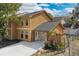 Exterior view of the home, showcasing the driveway, stonework, and wood siding at 486 Abba St, Altamonte Springs, FL 32714