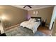 Comfortable bedroom featuring a ceiling fan, wood floors, and a plush rug at 5017 City St # 1932, Orlando, FL 32839
