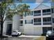 Exterior view of condo featuring screened balconies, attached garages, and traditional architectural details at 5017 City St # 1932, Orlando, FL 32839