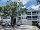Exterior view of condo featuring screened balconies, attached garages, and traditional architectural details at 5017 City St # 1932, Orlando, FL 32839