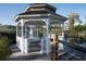 Charming gazebo situated on a wooden deck overlooking a picturesque lake with a fountain at 5017 City St # 1932, Orlando, FL 32839