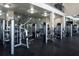 A well equipped gym with weight machines, mirrored walls and rubberized flooring at 5017 City St # 1932, Orlando, FL 32839