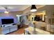 Comfortable living area with hardwood floors leading to a breakfast bar, kitchen, and main living space at 5017 City St # 1932, Orlando, FL 32839