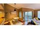 Living room with dining area, sliding glass door to the balcony, and wood flooring at 5017 City St # 1932, Orlando, FL 32839