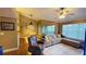 Spacious living room featuring hardwood floors, a ceiling fan, and balcony access with natural lighting at 5017 City St # 1932, Orlando, FL 32839