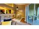 Open-concept living and dining areas showcasing barstool seating and access to an outdoor balcony at 5017 City St # 1932, Orlando, FL 32839