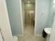 Bathroom featuring a glass-enclosed shower, light blue walls, and a modern pedestal sink at 510 Captiva Dr, Davenport, FL 33896