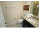 Bathroom featuring dark wood cabinets, granite countertops, and tiled shower at 510 Captiva Dr, Davenport, FL 33896