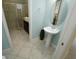 Bright bathroom featuring a pedestal sink, light blue walls, and a glass door shower at 510 Captiva Dr, Davenport, FL 33896