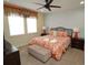 Comfortable bedroom with a floral-patterned bedspread and matching pillows, plus dark wood furnishings at 510 Captiva Dr, Davenport, FL 33896