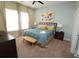 Comfortable bedroom with three large windows, ceiling fan, and en suite bathroom at 510 Captiva Dr, Davenport, FL 33896