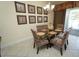 Dining room with seating for six, decorative seashell wall art and sliding doors to outside at 510 Captiva Dr, Davenport, FL 33896