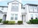 Exterior shot of a modern two-story townhouse featuring a well-kept lawn and walkway to the front door at 510 Captiva Dr, Davenport, FL 33896