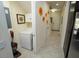 Hallway with a white washer and dryer behind a door and decorative wall art at 510 Captiva Dr, Davenport, FL 33896