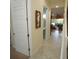 Hallway with tile flooring, featuring a seahorse art piece on the wall and leading to a bright living space at 510 Captiva Dr, Davenport, FL 33896