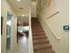 Carpeted staircase with white railing, connecting to a hallway with a bathroom and view of the living area at 510 Captiva Dr, Davenport, FL 33896