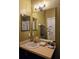 Bathroom with a modern vanity, gold fixtures, a stylish mirror, and decorative wall accents at 554 Pinebranch Cir, Winter Springs, FL 32708