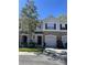 Inviting townhome featuring a well-manicured lawn and attached one car garage at 554 Pinebranch Cir, Winter Springs, FL 32708