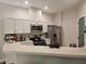 Kitchen area featuring stainless steel appliances, modern microwave, and ample counter space at 554 Pinebranch Cir, Winter Springs, FL 32708