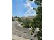 A street view of a neighborhood with white houses and green trees with a blue sky at 554 Pinebranch Cir, Winter Springs, FL 32708