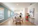 Cozy dining area with modern decor, and a view into the stylish kitchen with white cabinetry at 5591 Maddie Dr, Haines City, FL 33844