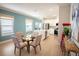 Inviting dining area open to a modern kitchen, featuring a glass table and artful decor at 5591 Maddie Dr, Haines City, FL 33844