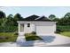 Charming single-story home with a two-car garage and well-maintained front lawn at 5591 Maddie Dr, Haines City, FL 33844