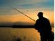 Silhouette of a person fishing at sunset on a tranquil lake with a calm, relaxing view at 5591 Maddie Dr, Haines City, FL 33844