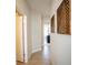 An interior hallway featuring natural wood-look tile and contemporary wall decor at 5591 Maddie Dr, Haines City, FL 33844