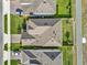 Aerial view of a well-maintained home with a brown roof and manicured lawn in a residential neighborhood at 565 Big Pine Ave, Minneola, FL 34715