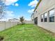 A lush green lawn with a white vinyl fence surrounds the yard and partially views house at 565 Big Pine Ave, Minneola, FL 34715