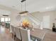 Dining room with hardwood floors, a modern chandelier, and seating for six at 565 Big Pine Ave, Minneola, FL 34715