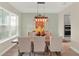 Dining room boasting abundant natural light, hardwood floors, and stylish furnishings at 565 Big Pine Ave, Minneola, FL 34715